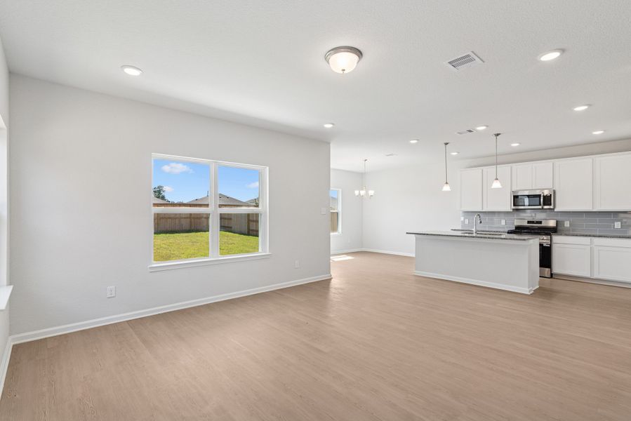 The Oriole II- Family Room into Kitchen. Sample image to be used for example only, colors, options and upgrades vary.