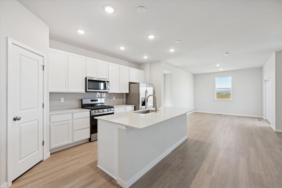 A kitchen with white cabinets.