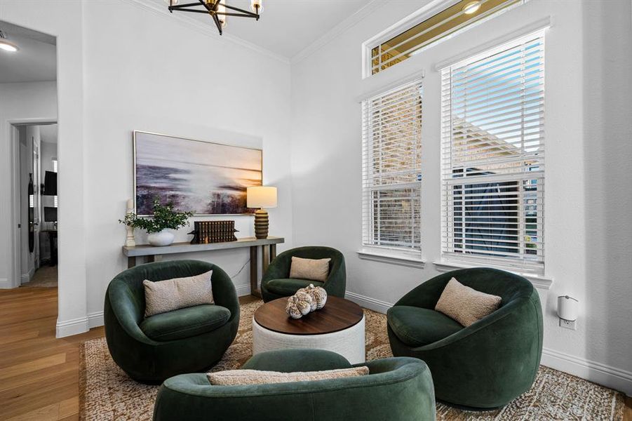 Sitting room featuring crown molding and a view of the front. Sitting room featuring crown molding and a view of the front.