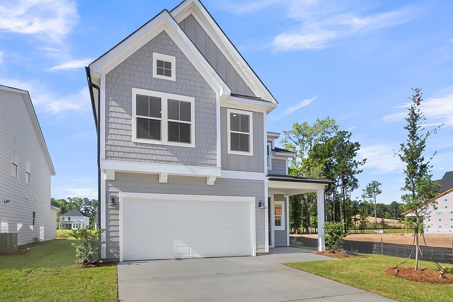 Front exterior of a new home in Pineland Preserve, Summerville, SC, highlighting curb appeal (Image 2). Front exterior of a new home in Pineland Preserve, Summerville, SC, highlighting curb appeal (Image 2).