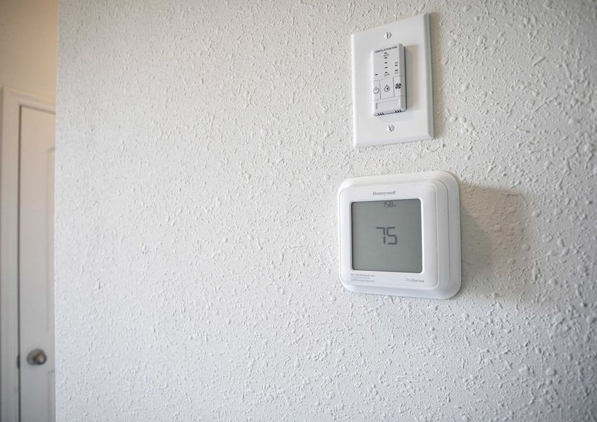 Harriet  completed model home featuring digital / programmable thermostat on white painted wall