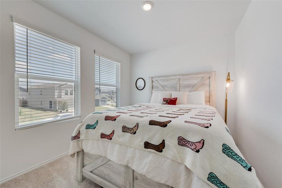 Bedroom featuring carpet flooring and baseboards Bedroom featuring carpet flooring and baseboards