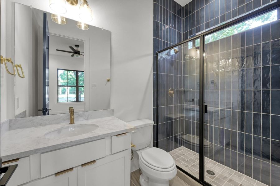 Secondary bathroom with dual sinks and modern tile shower. Secondary bathroom with dual sinks and modern tile shower.