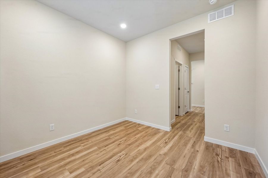 A room with a wood floor and a wood floor.