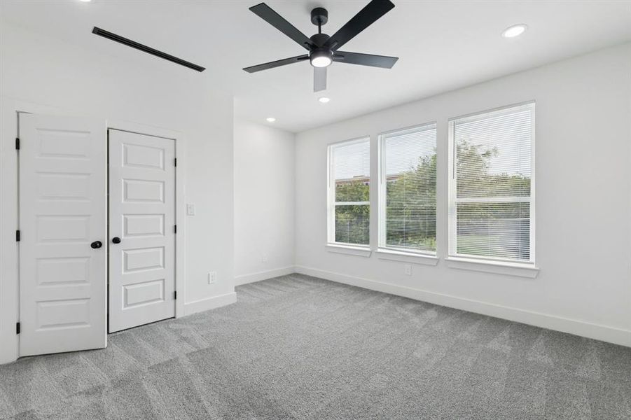 Unfurnished bedroom featuring light colored carpet, a closet, recessed lighting, and ceiling fan