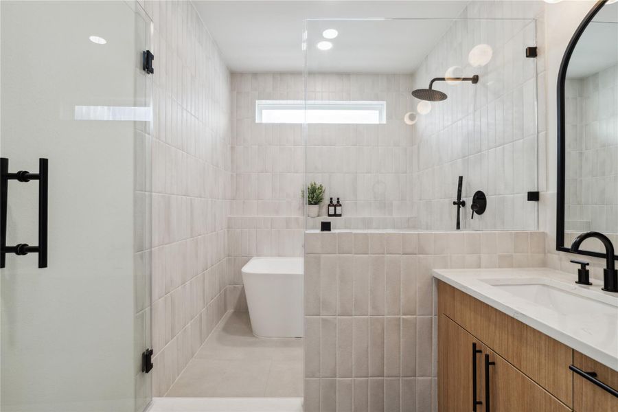 The freestanding tub becomes a sculptural centerpiece—perfect for quiet moments of restoration.