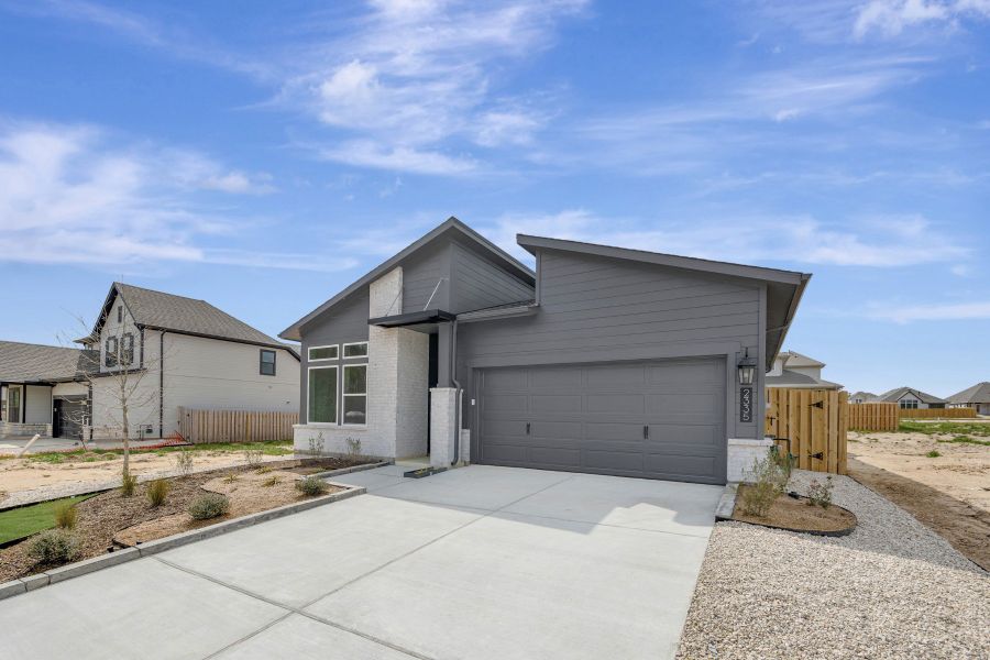 Front exterior of a new home in COLTON - Reserve Collection, Todd Mission, TX, highlighting curb appeal (Image 2). Front exterior of a new home in COLTON - Reserve Collection, Todd Mission, TX, highlighting curb appeal (Image 2).