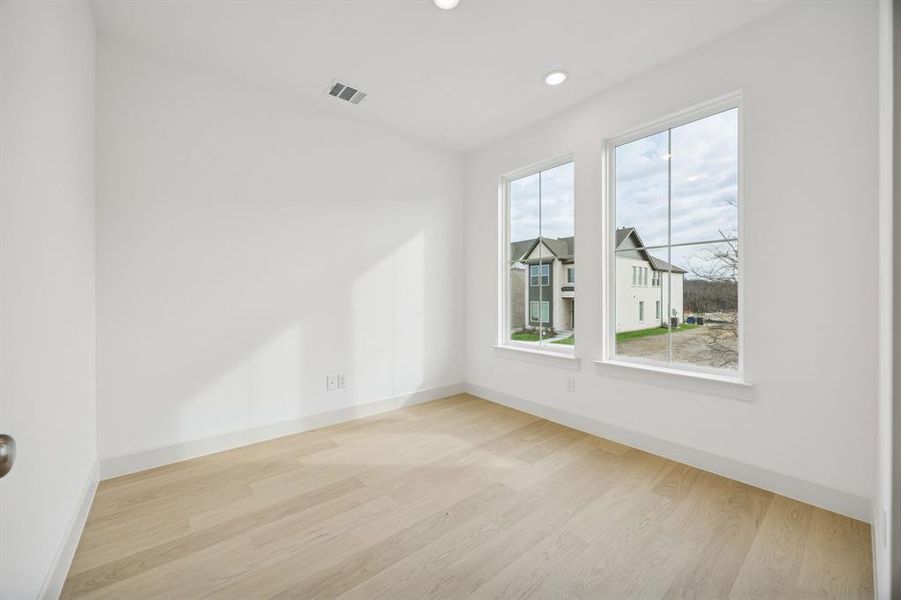 The professional working from home will appreciate this private home office with oversized windows providing tons of natural light.