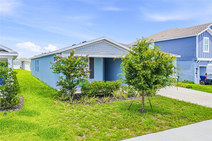 Front exterior of a new home in Peace Creek Reserve, Winter Haven, FL, highlighting curb appeal (Image 21).