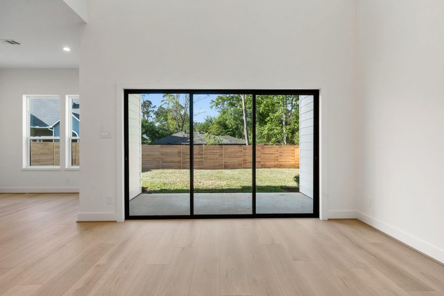 The elegant sliding doors, which open from either side, offer a stunning view of the covered patio and the spacious, peaceful backyard—perfect for relaxing or entertaining outdoors. The elegant sliding doors, which open from either side, offer a stunning view of the covered patio and the spacious, peaceful backyard—perfect for relaxing or entertaining outdoors.