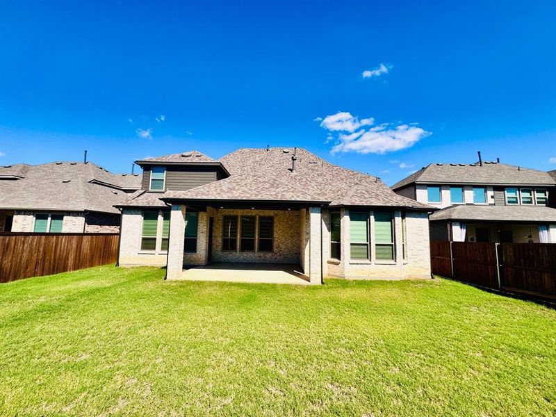 Back of property featuring a patio area and a yard