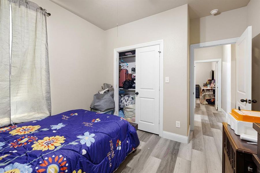 Bedroom with hardwood / wood-style flooring and a closet