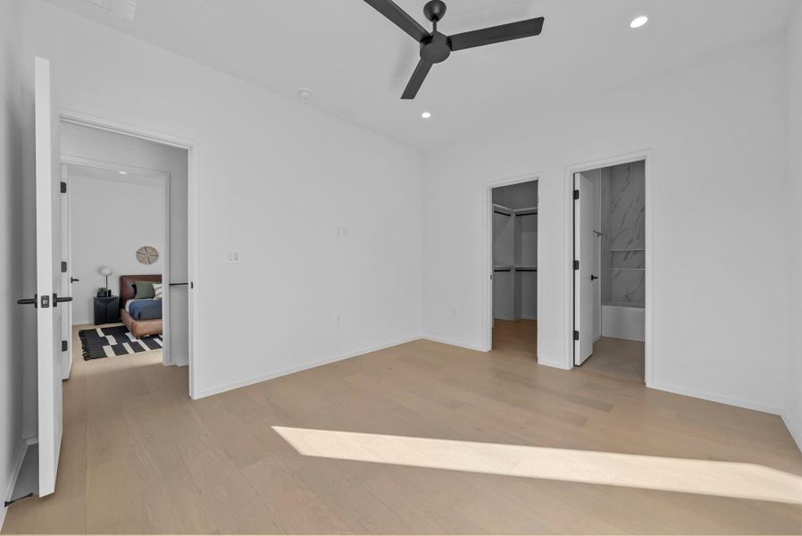 Secondary bedroom with white oak floor, walk in closet and en-suite bath Secondary bedroom with white oak floor, walk in closet and en-suite bath