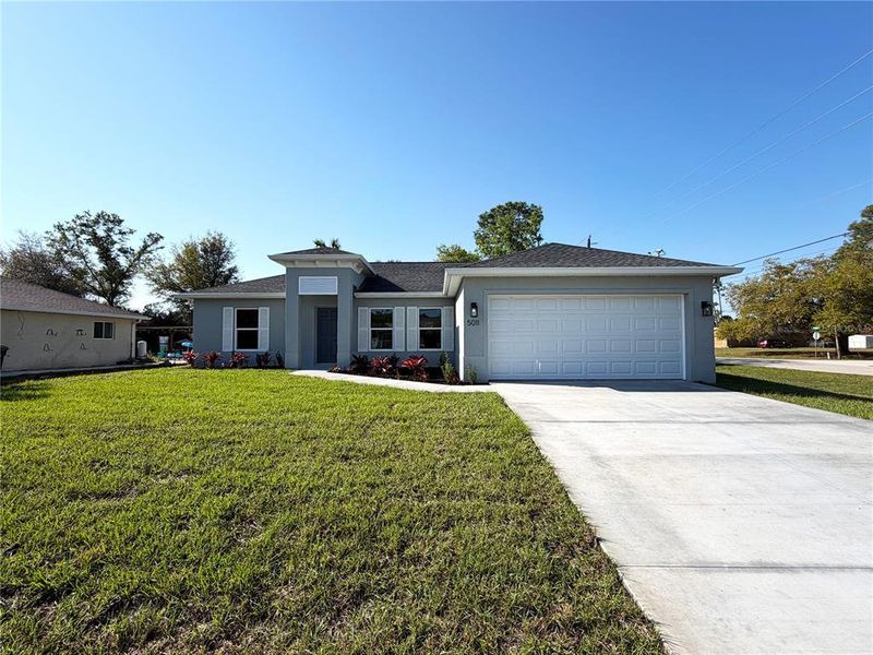 Front exterior of a new home in , North Port, FL, highlighting curb appeal (Image 1). Front exterior of a new home in , North Port, FL, highlighting curb appeal (Image 1).