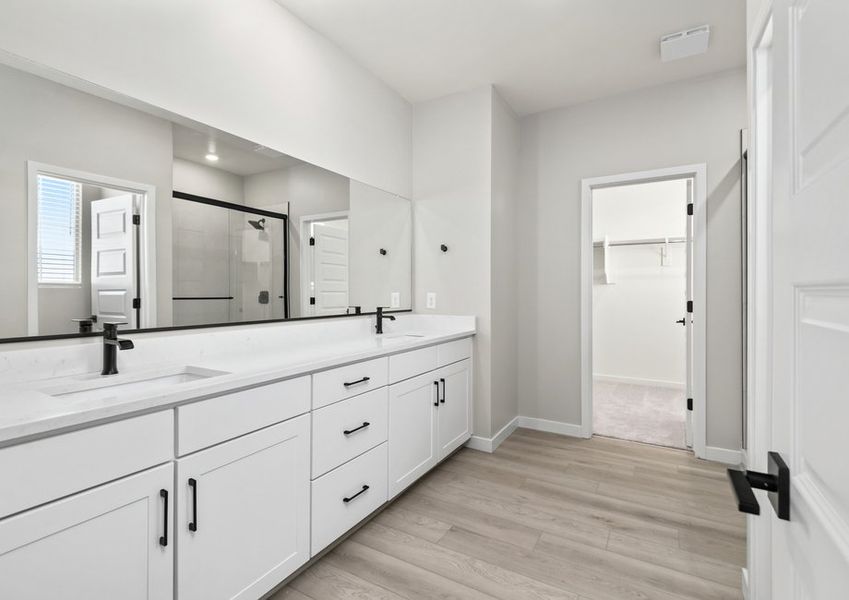 Enjoy a beautiful glass-enclosed shower and dual-vanity sinks.