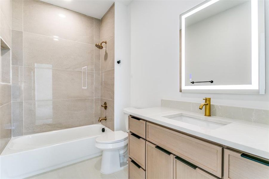 Full bathroom featuring vanity and shower / tub combination Full bathroom featuring vanity and shower / tub combination