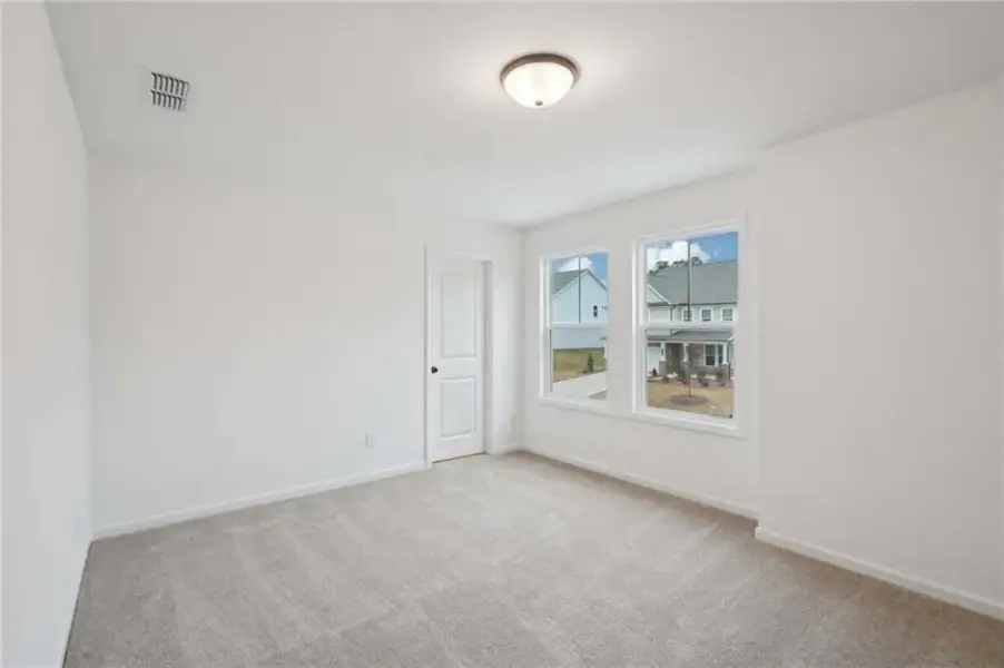 Spacious, unfurnished interior of a new home in Eastlyn Crossing, Flowery Branch (Image 13).