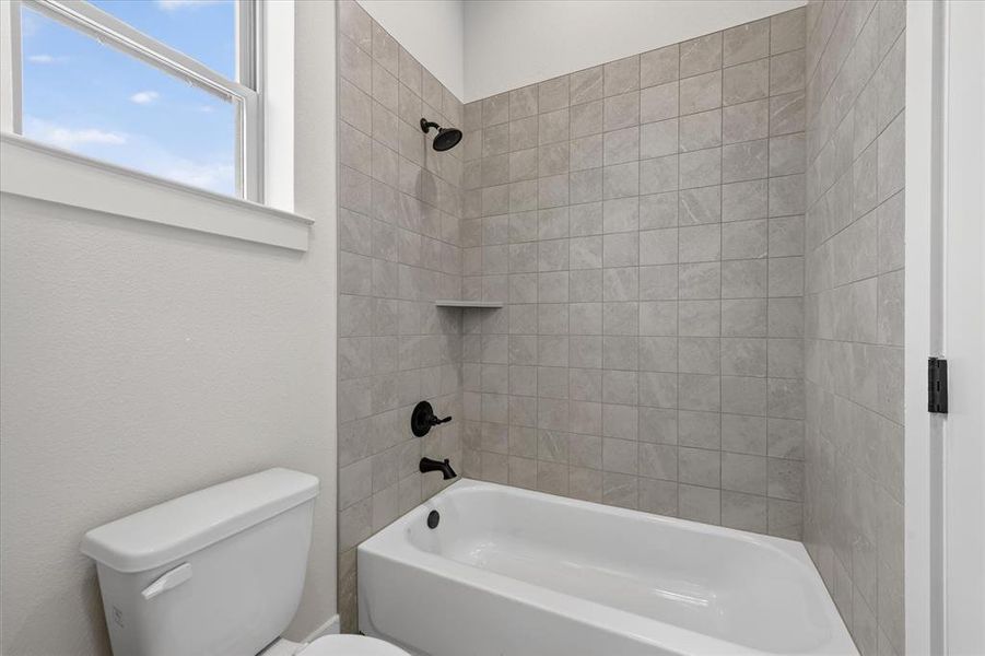 Bathroom featuring toilet and  shower combination