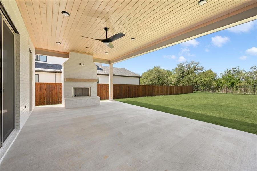 View of patio / terrace with an outdoor brick fireplace and ceiling fan