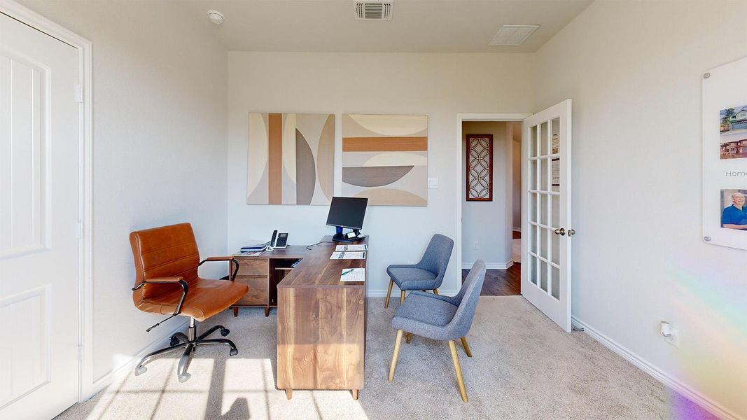 Office space with light carpet and french doors Office space with light carpet and french doors