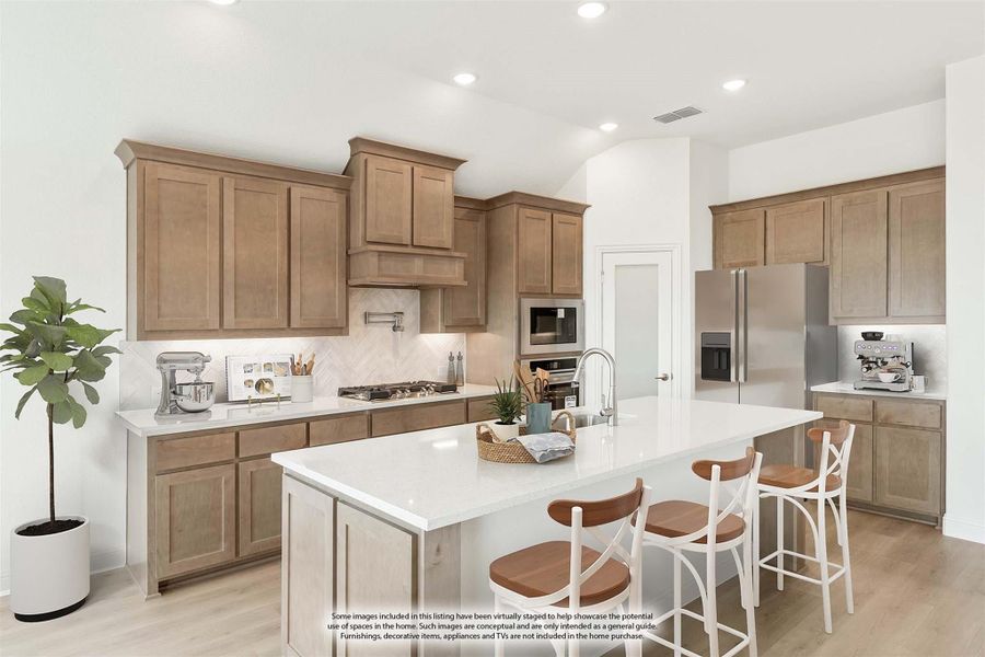 Kitchen with tan wood cabinets, white quartz island with bar stools, and stainless steel appliances Kitchen with tan wood cabinets, white quartz island with bar stools, and stainless steel appliances