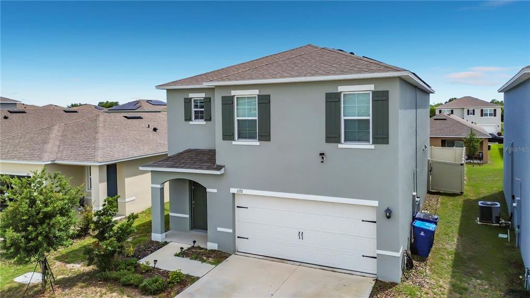 Front exterior of a new home in , Davenport, FL, highlighting curb appeal (Image 26). Front exterior of a new home in , Davenport, FL, highlighting curb appeal (Image 26).