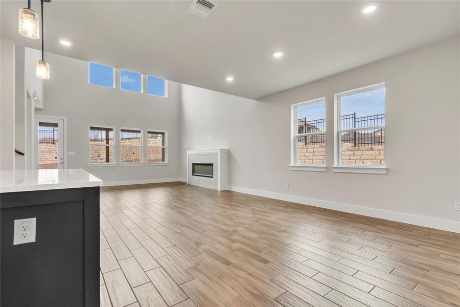 A spacious living area with soaring ceilings and abundant natural light from high-set windows.