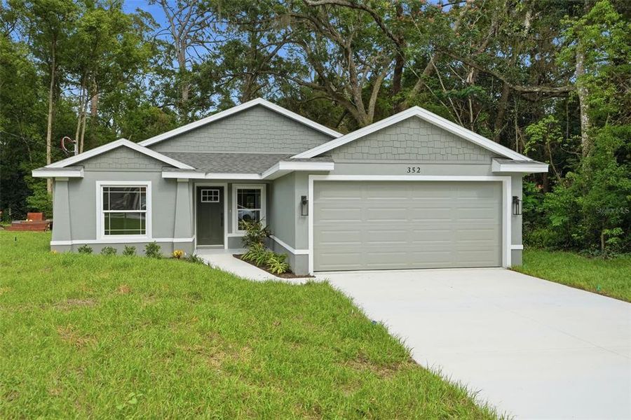 Front exterior of a new home in , Masaryktown, FL, highlighting curb appeal (Image 27).