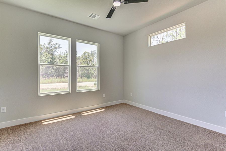 Carpeted spare room.