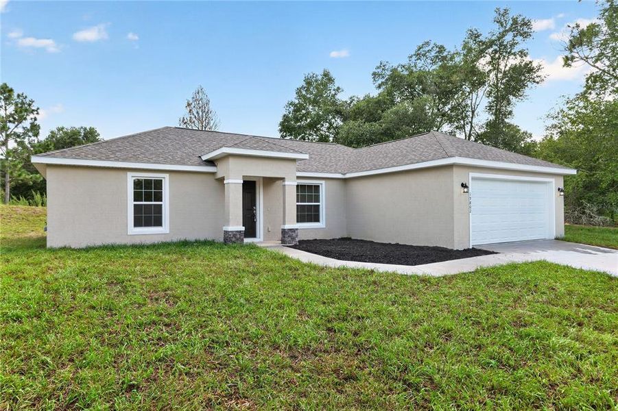 Front exterior of a new home in , Dunnellon, FL, highlighting curb appeal (Image 27).