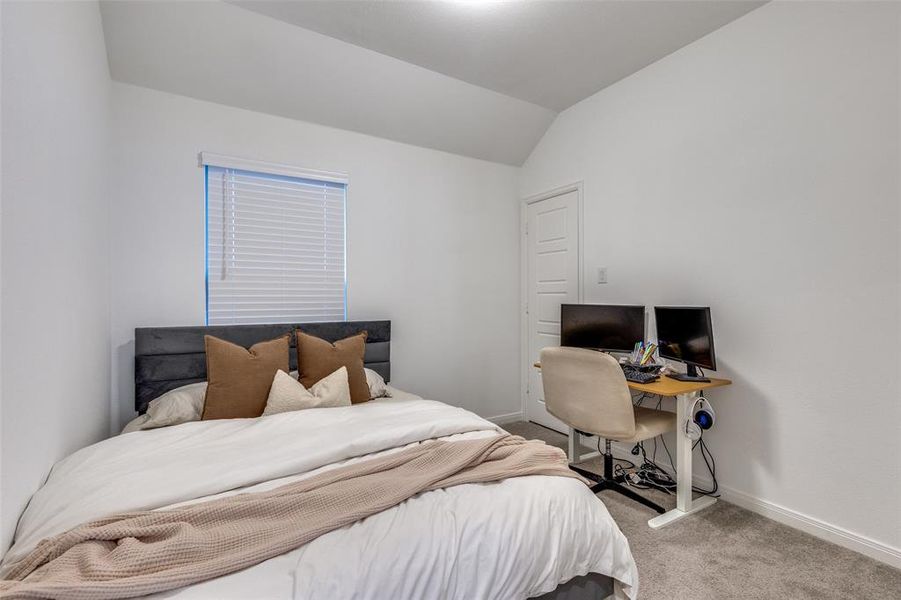Bedroom featuring light colored carpet