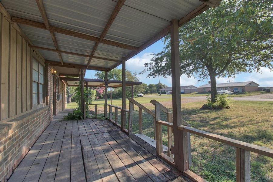 Wooden deck featuring a lawn Wooden deck featuring a lawn