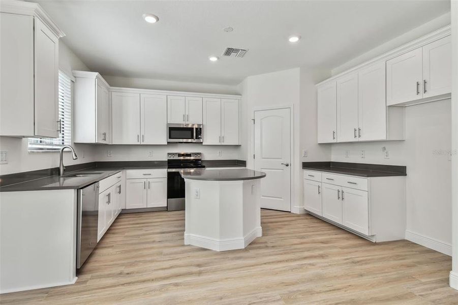 Photos are not the home listed, but same floor plan.