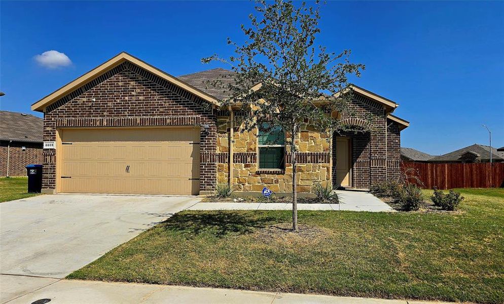View of front facade featuring brick siding, a garage, and driveway View of front facade featuring brick siding, a garage, and driveway