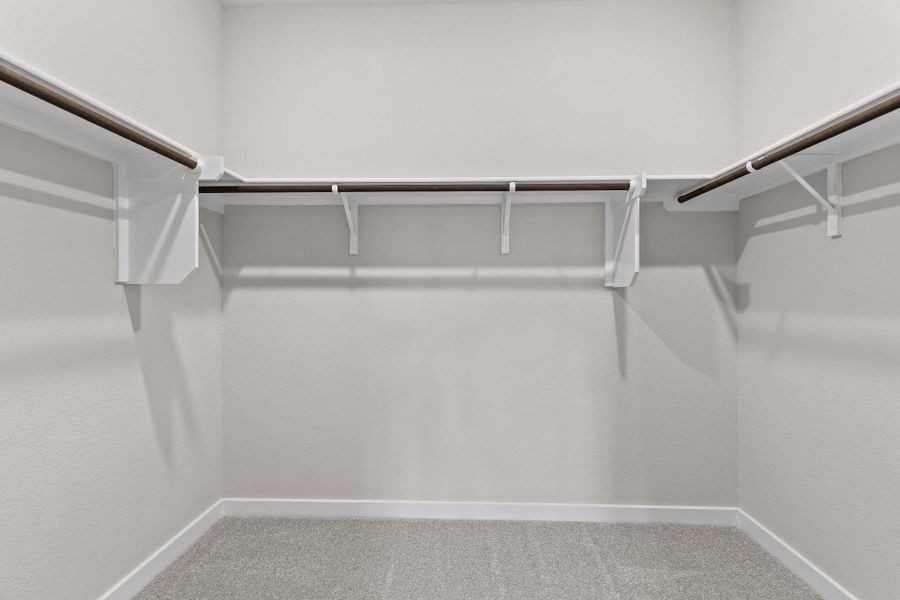 Walk-in closet in Primary Bedroom Walk-in closet in Primary Bedroom