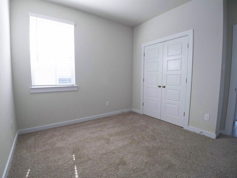Unfurnished bedroom with a closet and carpet floors Unfurnished bedroom with a closet and carpet floors