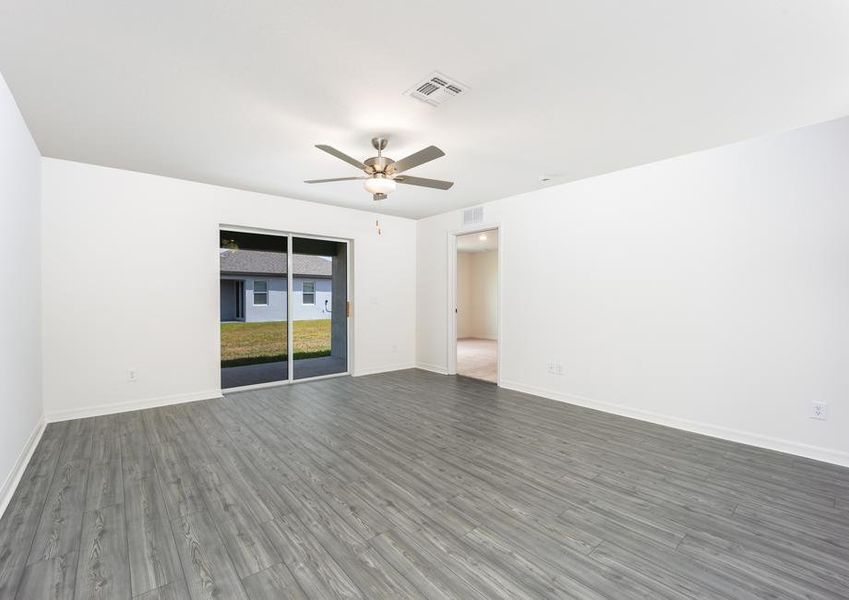 A sliding door in the family room leads to the covered back patio