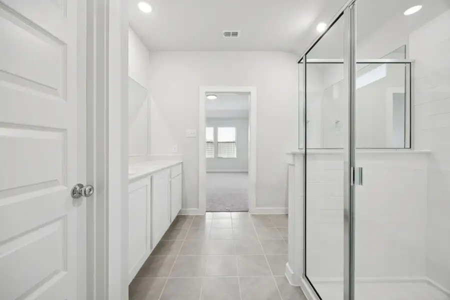Primary Bathroom in the Heisman home plan by Trophy Signature Homes – REPRESENTATIVE PHOTO