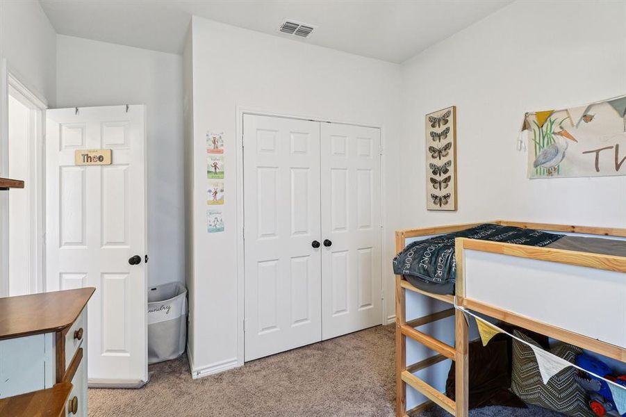 Bedroom with light carpet and a closet Bedroom with light carpet and a closet