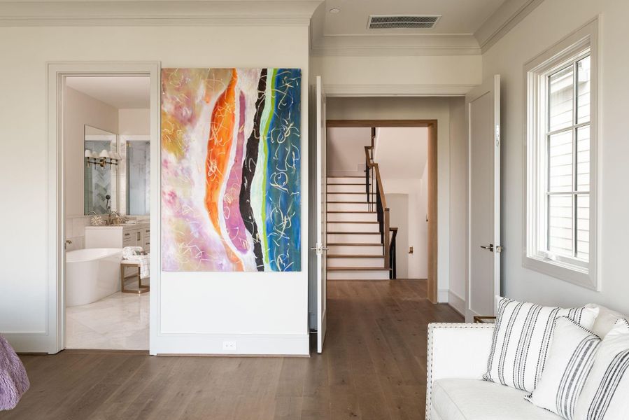 The primary bedroom has a wide entrance, framed with white oak. It opens onto a luxurious primary bathroom with a truly magnificent primary closet beyond. The primary bedroom has a wide entrance, framed with white oak. It opens onto a luxurious primary bathroom with a truly magnificent primary closet beyond.