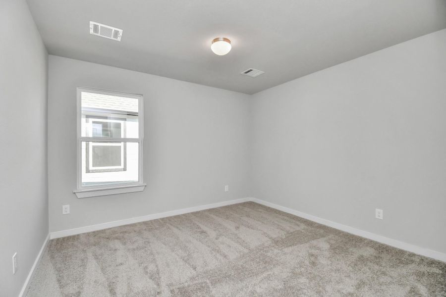 Another view of the secondary bedroom. Sample photo of completed home with similar floor plan. Actual colors and selections may vary. Another view of the secondary bedroom. Sample photo of completed home with similar floor plan. Actual colors and selections may vary.