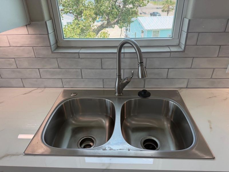 Stainless steal double sink with disposal.