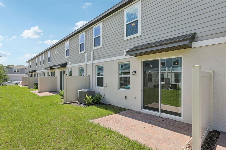 Exterior details and patio area of a home in The Meadow at Crossprairie Townes, St. Cloud (Image 27).