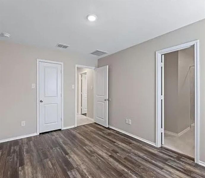 Unfurnished bedroom with dark wood-style floors