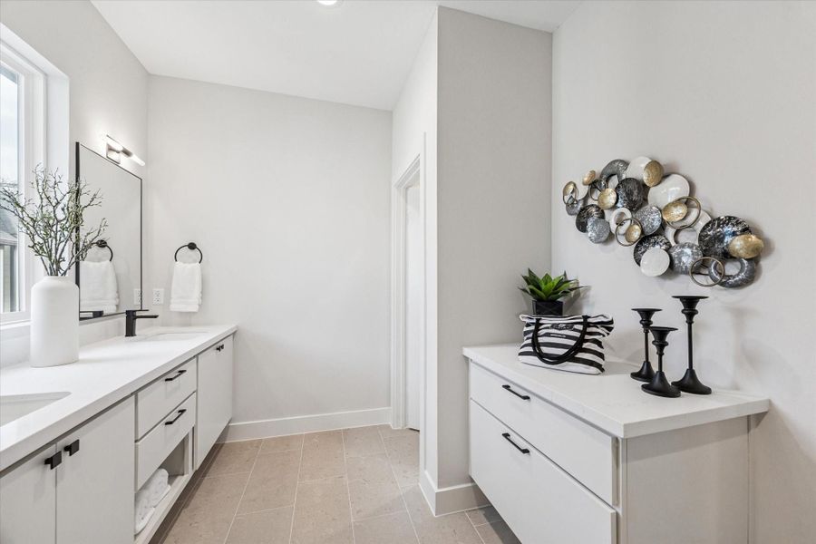 The primary bath offers an abundance of storage, including deep drawers perfect for keeping all your essentials organized.