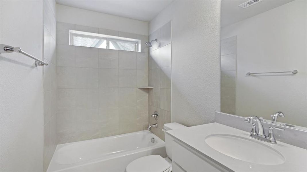 Bathroom with a textured wall, tub / shower combination, and vanity Bathroom with a textured wall, tub / shower combination, and vanity
