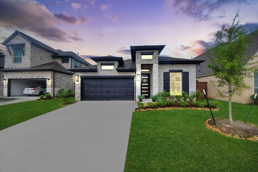 This is a modern, single-story brick home with a two-car garage. It features a well-maintained front yard, lush landscaping, and a spacious driveway. The sunset backdrop adds charm and warmth to the property.