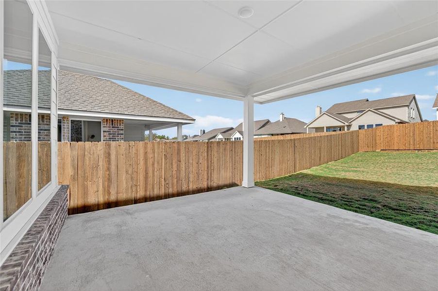 Fenced backyard with a patio area