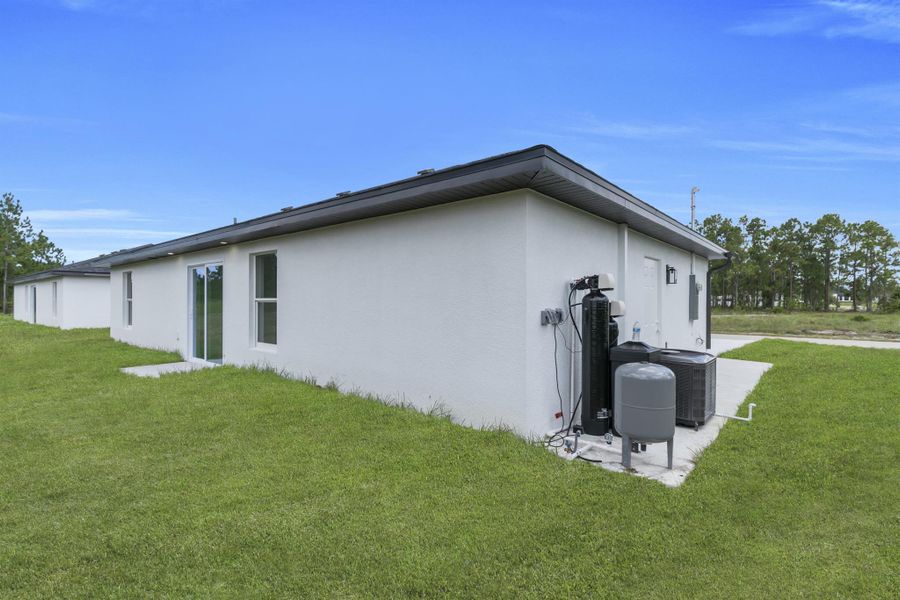 Front exterior of a new home in , Lehigh Acres, FL, highlighting curb appeal (Image 17).