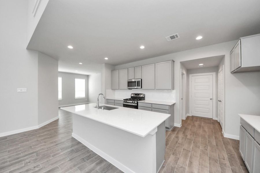 This kitchen is by far any chef’s dream! This spacious kitchen features high ceilings, light stained wood cabinets, granite countertop, SS appliances, modern tile backsplash, recessed lighting, extended counter space, granite kitchen island with double sink, and space for breakfast bar, and a walk-in pantry all overlooking your huge family room. This kitchen is by far any chef’s dream! This spacious kitchen features high ceilings, light stained wood cabinets, granite countertop, SS appliances, modern tile backsplash, recessed lighting, extended counter space, granite kitchen island with double sink, and space for breakfast bar, and a walk-in pantry all overlooking your huge family room.